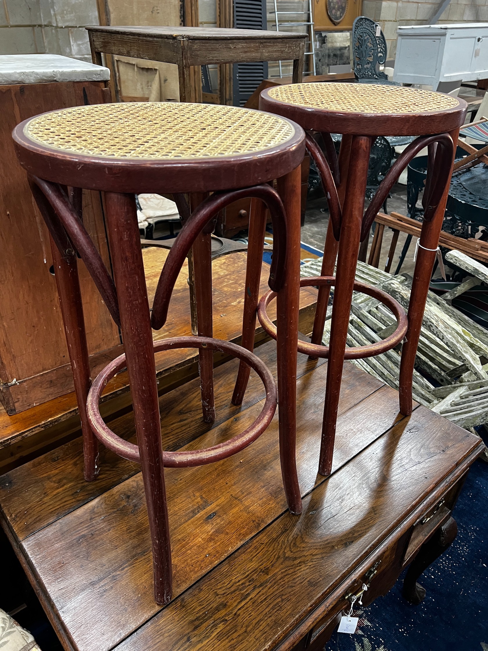 A pair of caned bentwood bar stools, height 76cm